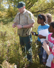 A Naturalist leading a group of park visitors 